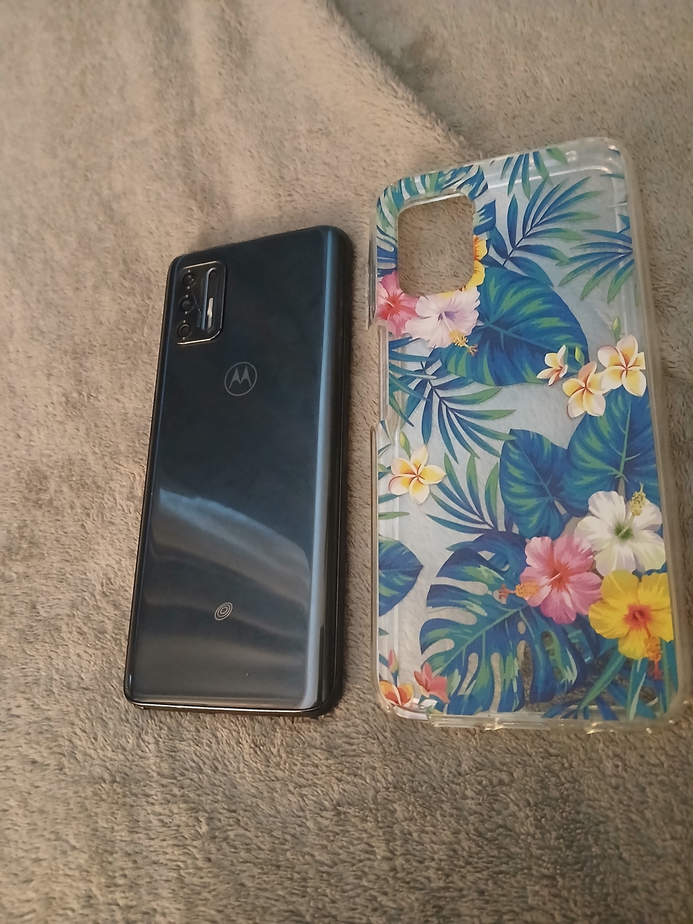Motorola Navy Blue Smartphone with Floral Clear Case Shown
